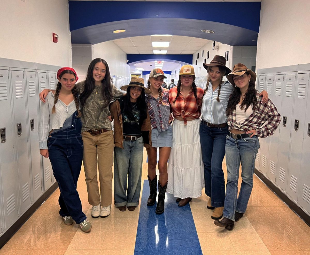 Students show off their Spirit Week attire during "Country or Country Club" theme day in the
hallway.