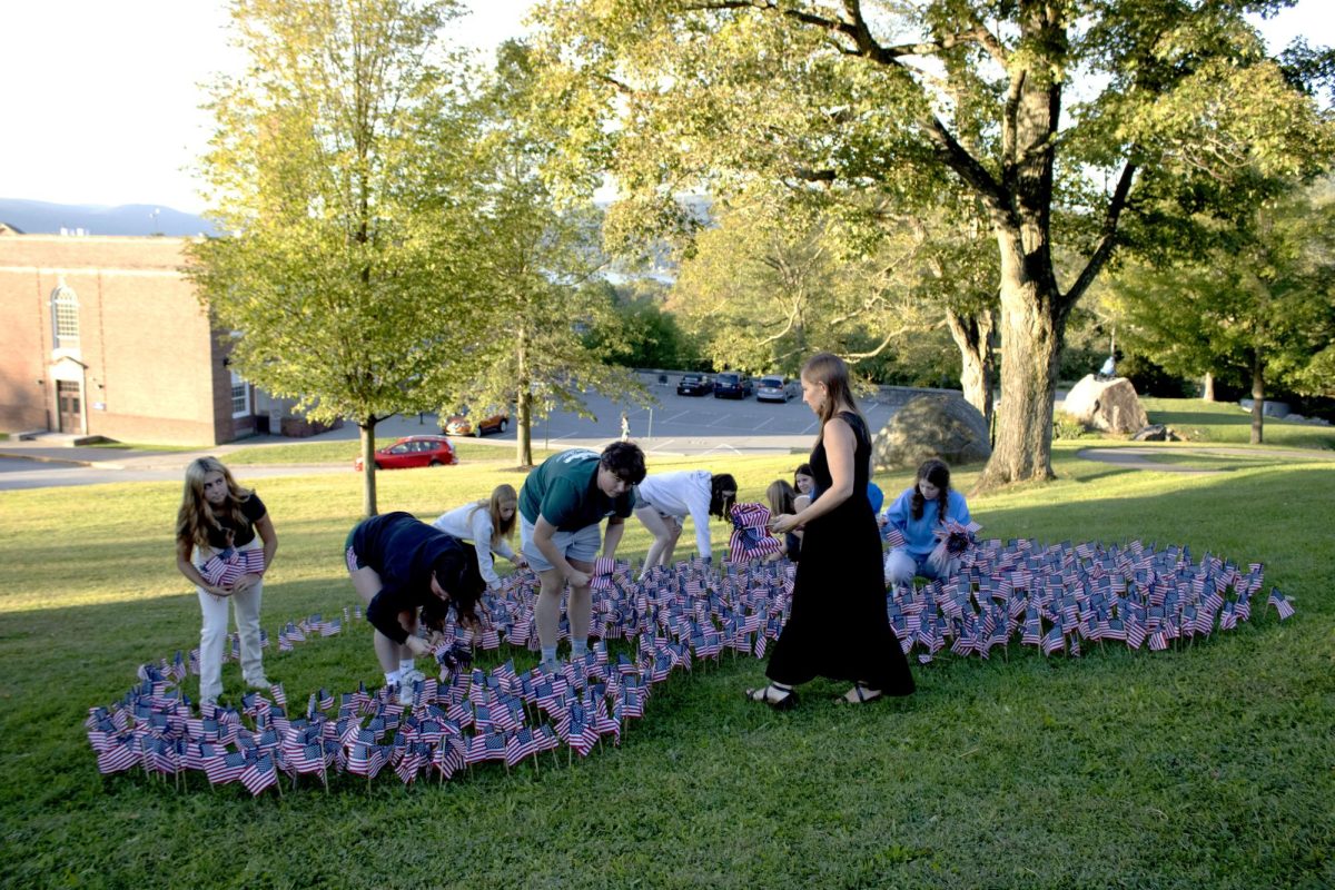 The History Club sets up flags as part of the 9/11 memorial.