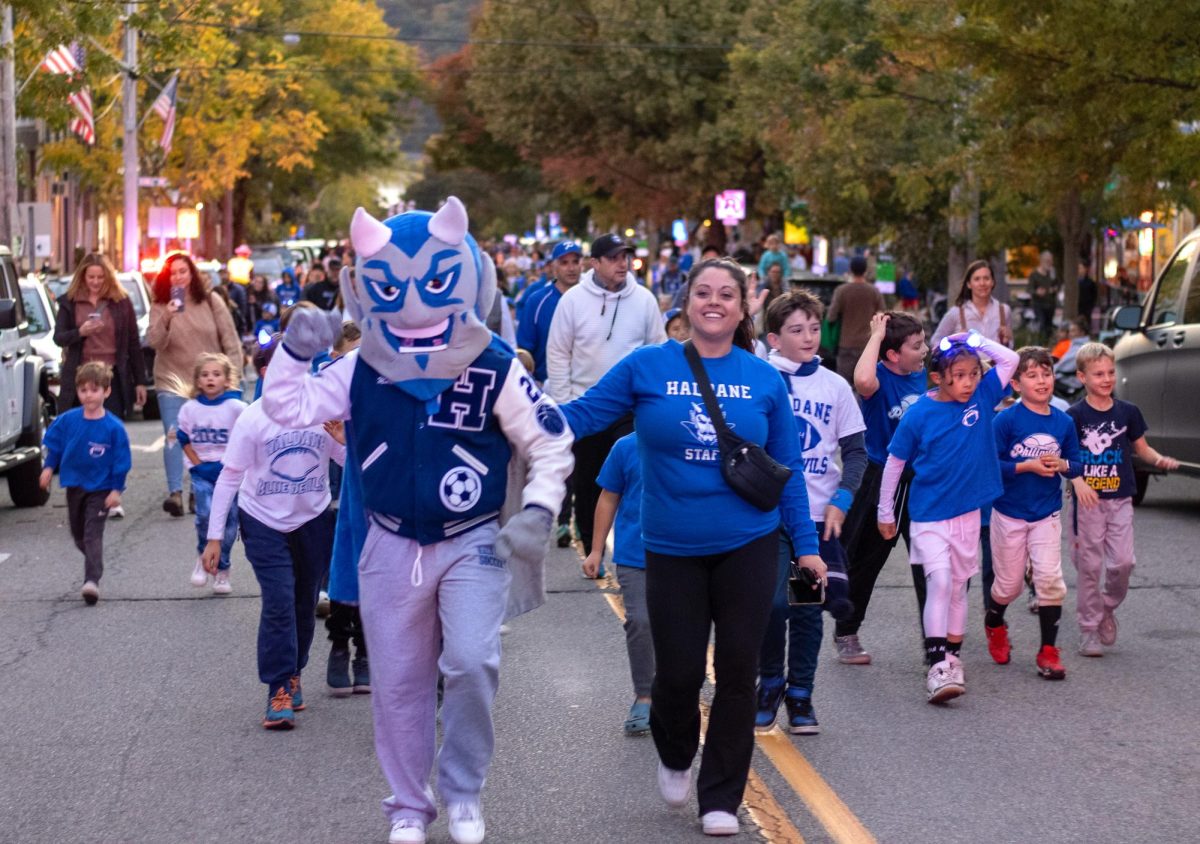 The Haldane Blue Devil and Haldane math teacher Kristen Peparo lead the charge up Main Street to the stands before the Homecoming football game on Oct. 18.