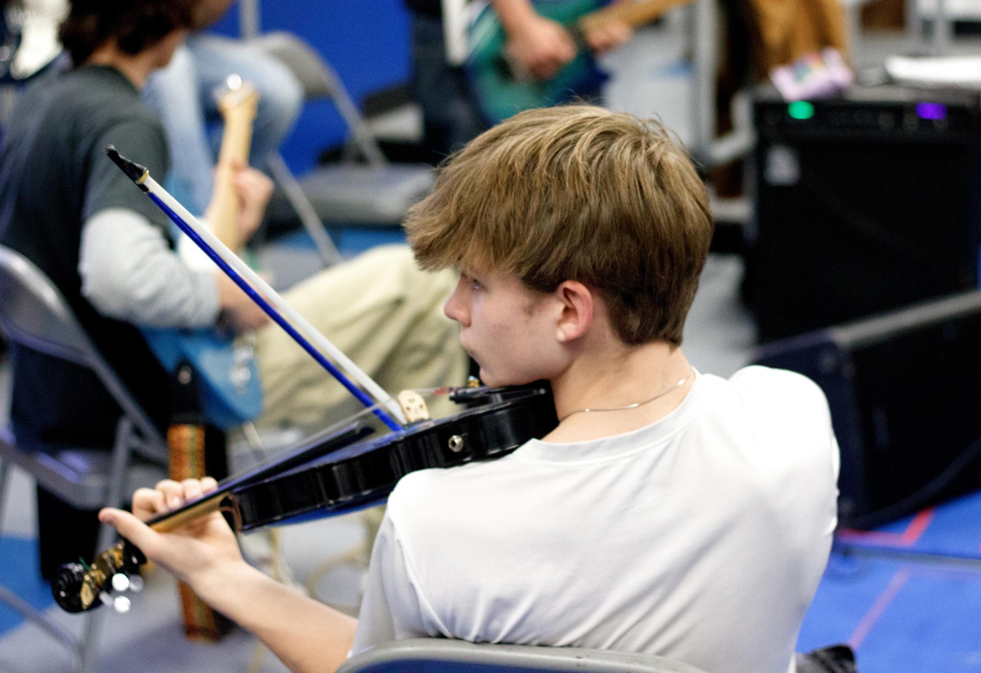 Junior Lucius Bell focuses on his violin during rehearsal for Haldane High School’s rock and roll band, Blues Devils, on Thursday January 9th. 