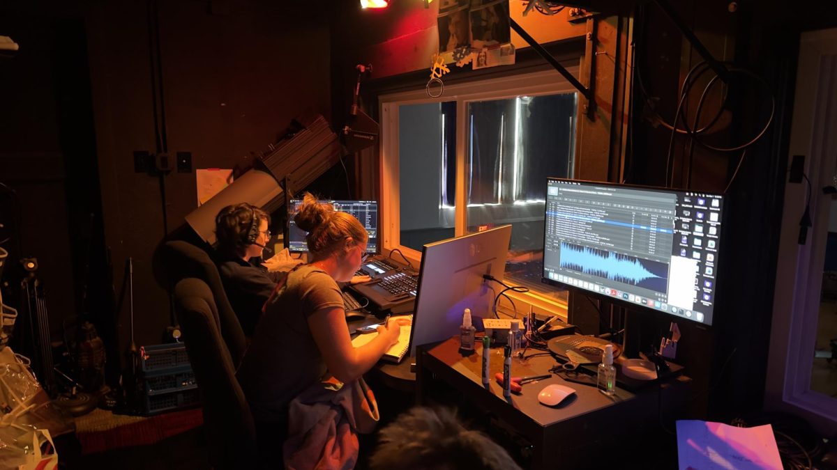 (L to R) August O'Neil and Caroline Sniffen work the tech booth during Tech Week in the Haldane auditorium.