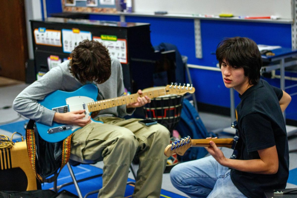 (L to R) Henry Schimming and James Frommer, juniors, jam out at practice 