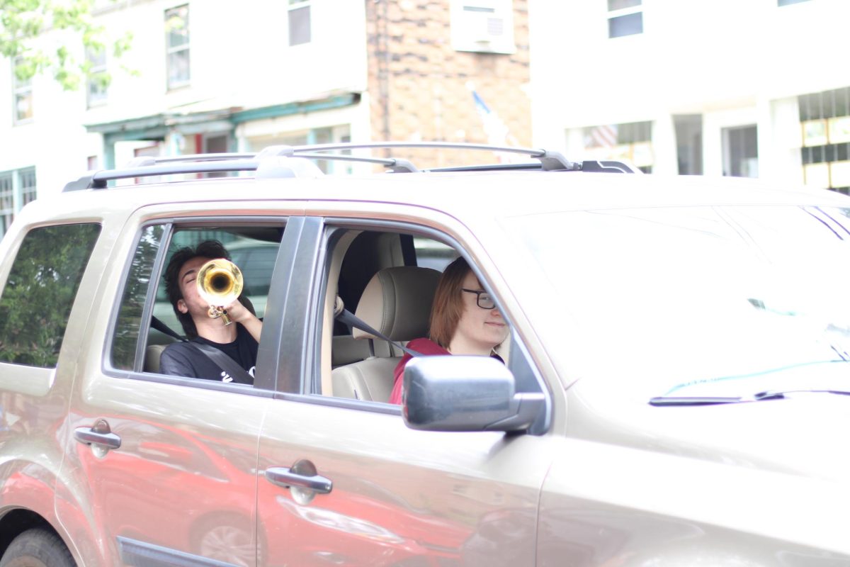 Haldane seniors Oliver Petkus and Frederick Hohenberger "scoop the loop" during the traditional caravan down Main St. in Cold Spring, N.Y. on Tuesday June 10, 2025 as part of Haldane seniors' last day festivities.