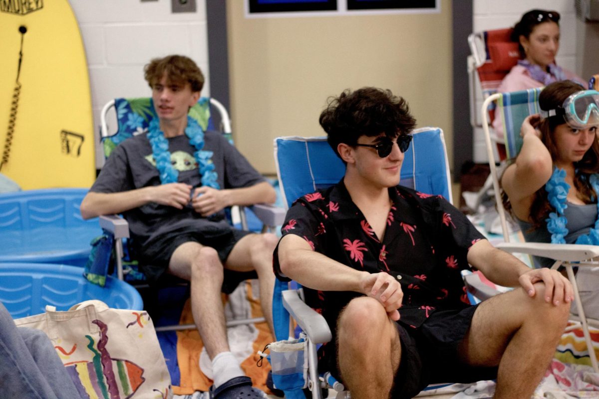 Haldane seniors Charles Ferreira and Amelia Alayon enjoy the "beach" that was set up in the high school's front hallway as part of the Senior Prank on Tuesday, June 10, 2025. Class of 2025 festivities continued throughout the day, including a breakfast served to teachers and a slip and slide stunt.