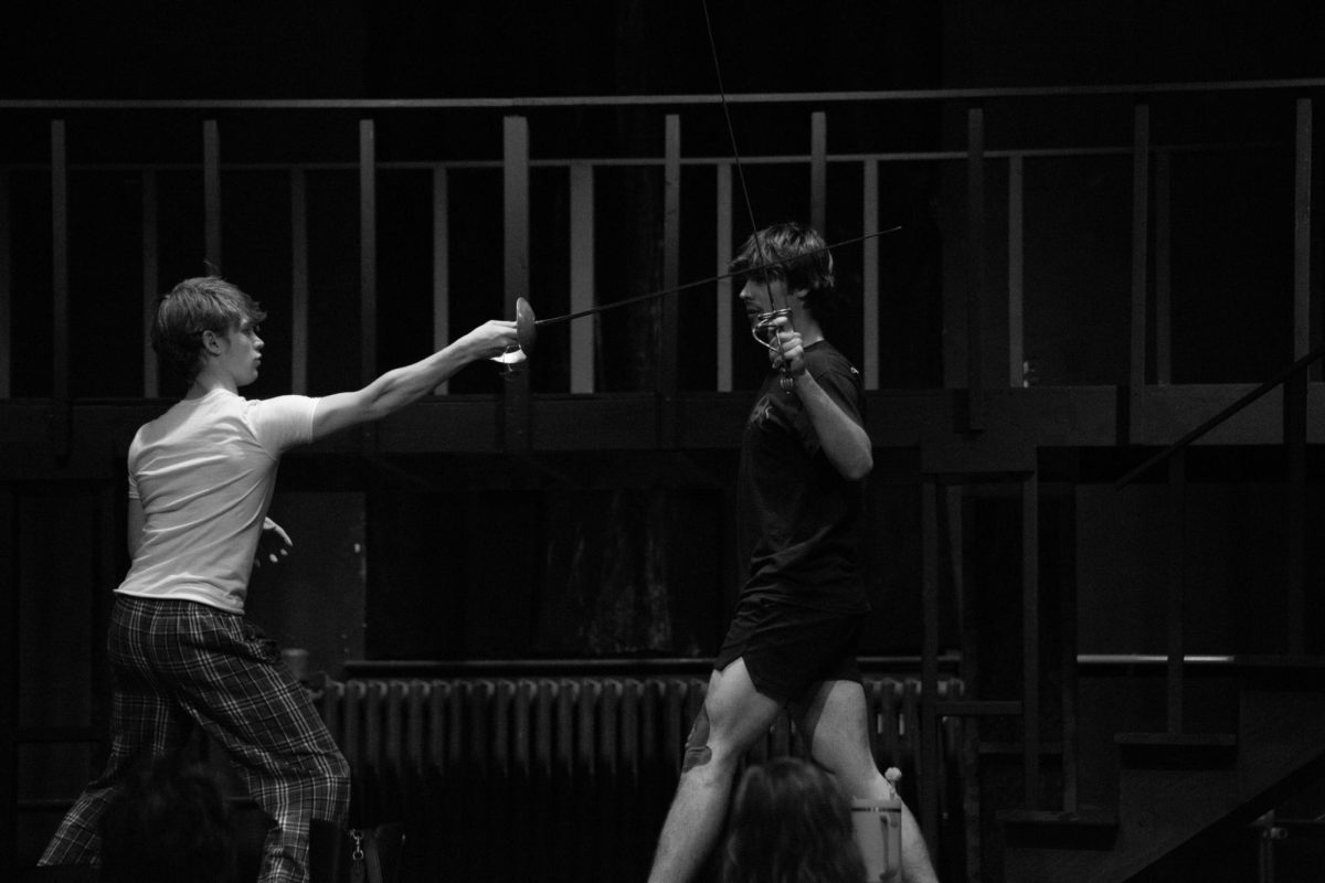 Seniors Lucky Bell and Merrick Williams practice their sword fighting techniques during high school play rehearsal on Wednesday, October 29, 2025.