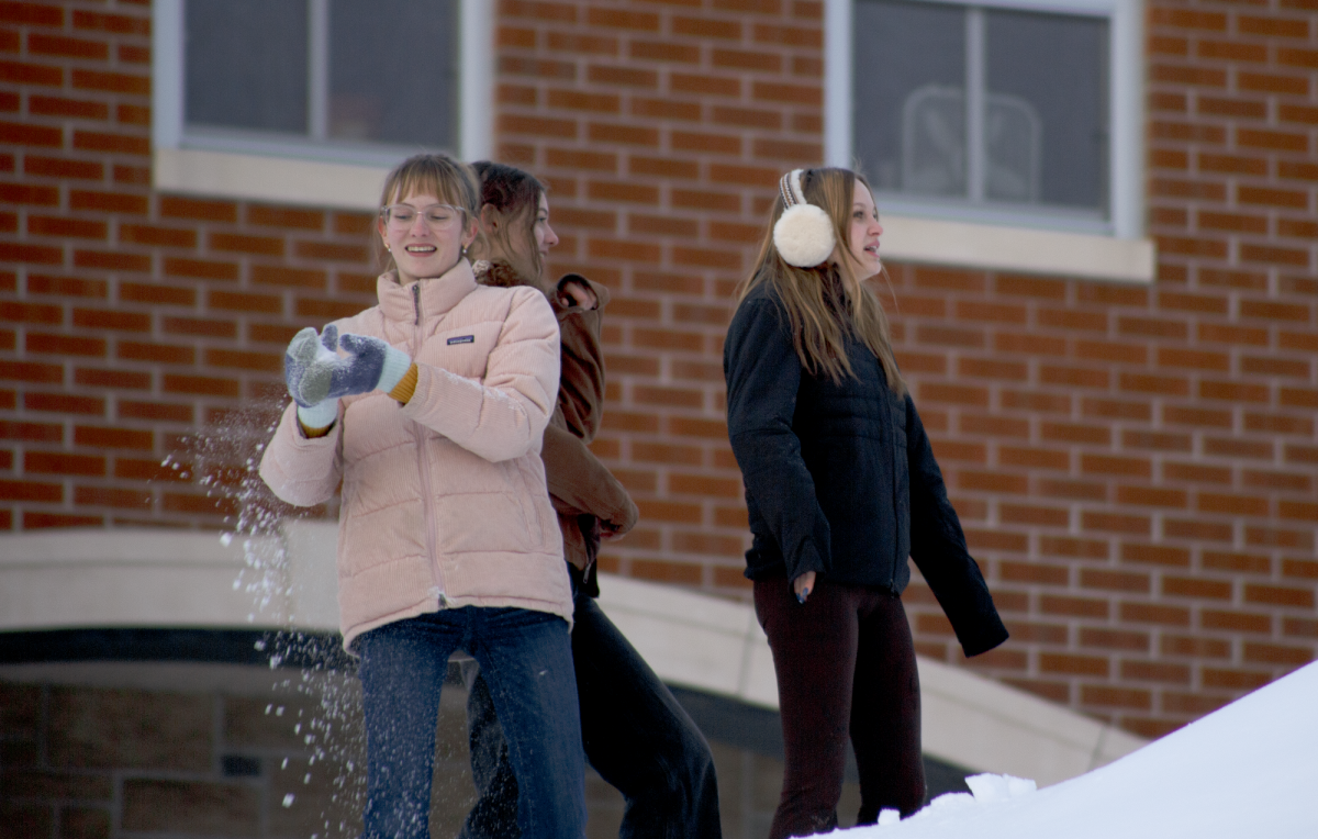 Senior Louisa Schimming and juniors Frances Donahue and Ruby McCormick participate in a snowball fight on the high school hill while taking a break from the Outlook print meeting on Wednesday, January 28, 2026. Highlights of students enjoying the winter weather continue on page 7.