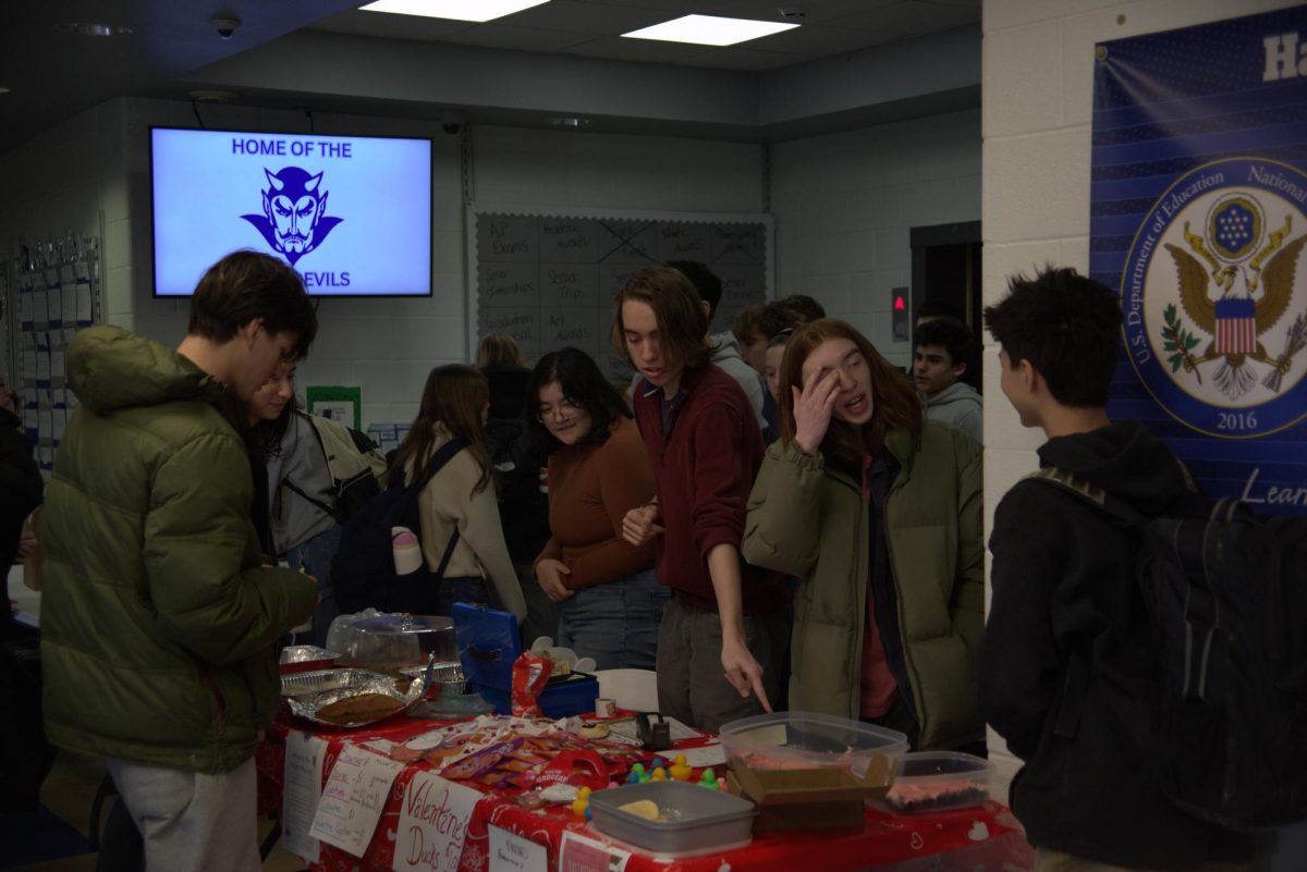 Juniors Alexa Arcigal, Lincoln Wayland, and Julian Costantine sell baked goods on Thursday, Feb. 12, 2026.
