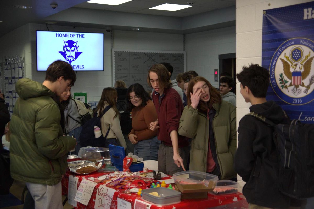 Juniors Alexa Arcigal, Lincoln Wayland, and Julian Costantine sell baked goods on Thursday, Feb. 12, 2026.