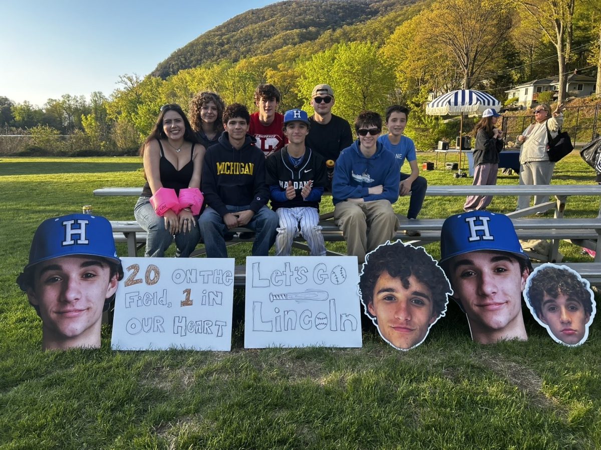 Haldane students Lucia Petty, Eowyn Kolarek, Gabe Rotenberg, George Stubbs, Arthur Owens, Leo Grocott, and Sawyer McCarthy celebrate baseball player Lincoln McCarthy at his senior night on Friday, April 24, 2026. Fans brought posters to celebrate the team's sole senior.