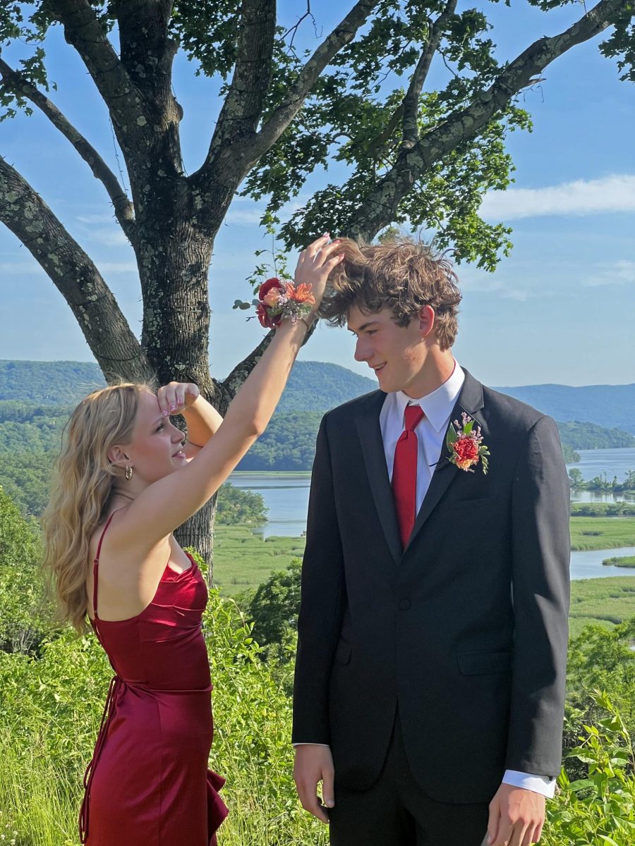 Junior Ruby McCormick adjusts senior George Stubbs' hair.